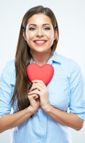 Smiling woman heart hold. White background isolated.